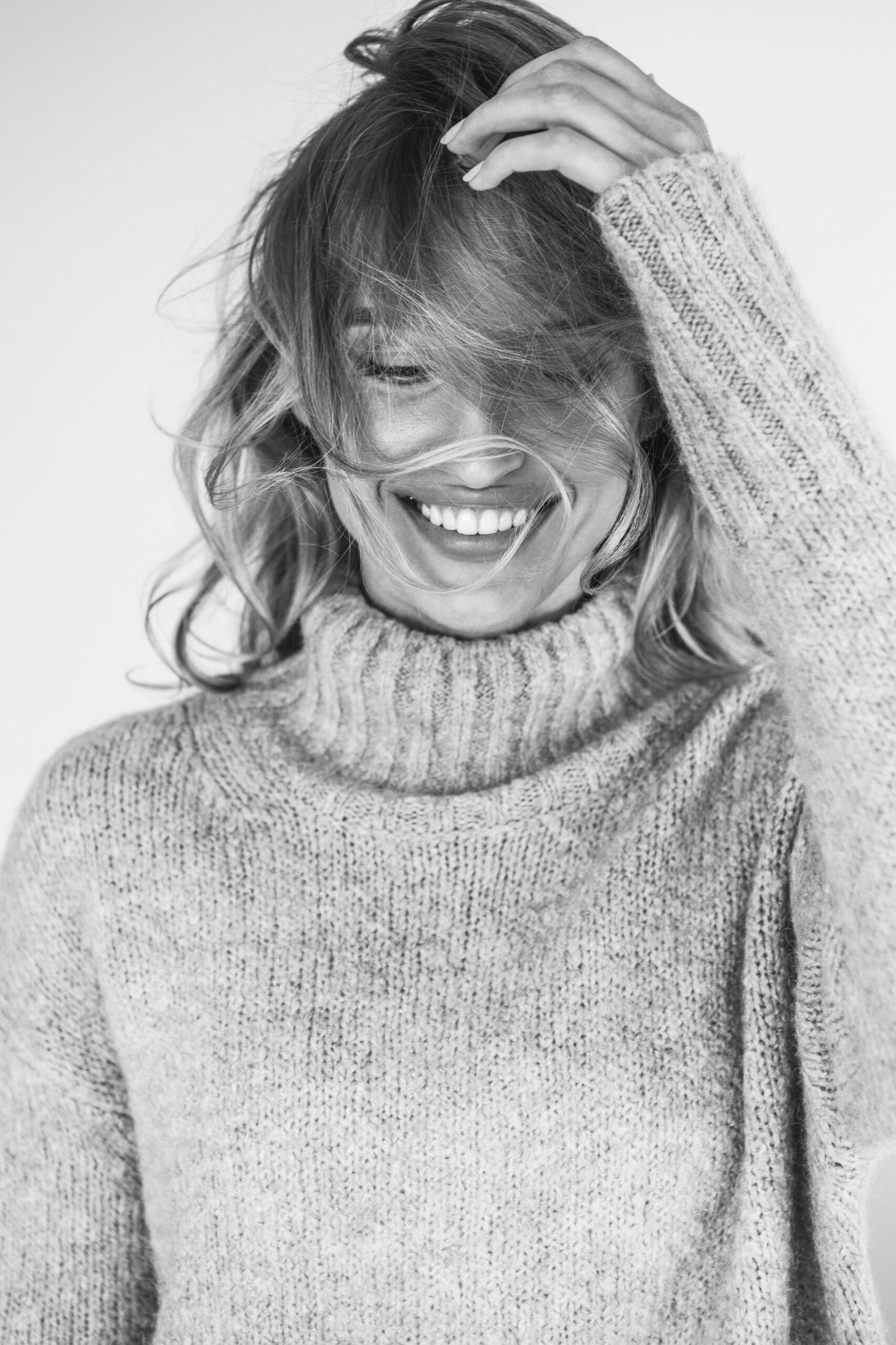 close-up-smiling-young-woman-against-wall (1)