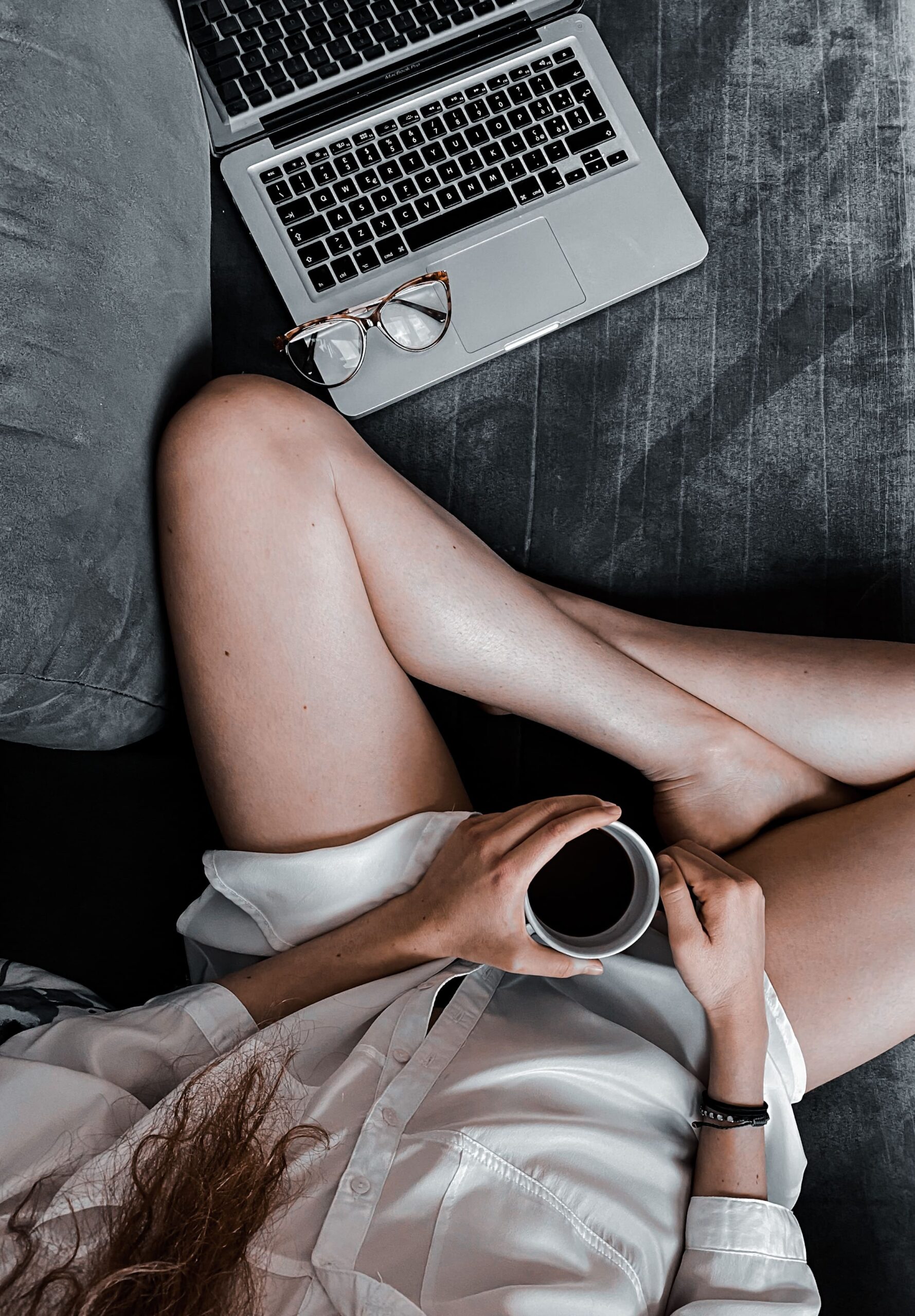 low-section-woman-holding-coffee-cup-while-sitting-floor (1) (1)